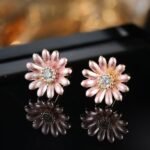 Niche daisy flower enamel necklace earring set wholesale featuring a crescent arrangement of multi-colored enamel daisy blossoms with pave zircon centers and matching daisy stud earrings from junejewelry.com