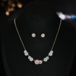 Niche daisy flower enamel necklace earring set wholesale featuring a crescent arrangement of multi-colored enamel daisy blossoms with pave zircon centers and matching daisy stud earrings from junejewelry.com