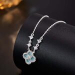 Niche four leaf clover pendant necklace wholesale featuring a four-petal clover motif framed with micro-pave cubic zirconia and round crystal stations along the chain from junejewelry.com