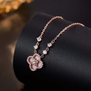 Niche four leaf clover pendant necklace wholesale featuring a four-petal clover motif framed with micro-pave cubic zirconia and round crystal stations along the chain from junejewelry.com
