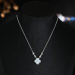 Niche four leaf clover pendant necklace wholesale featuring a four-petal clover motif framed with micro-pave cubic zirconia and round crystal stations along the chain from junejewelry.com