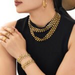Three-row geometric pyramid stud choker necklace and matching bracelet set in 18K gold plated and silver 316L stainless steel finishes.