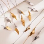 Stainless steel abstract twisted ribbon geometric pendant necklace, chain bracelet, and drop earrings set.