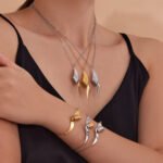 Stainless steel abstract twisted ribbon geometric pendant necklace, chain bracelet, and drop earrings set.