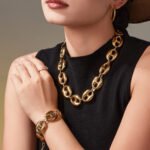 Stainless steel chunky coffee bean link chain necklace and matching bracelet set in gold, silver, and two-tone finishes.