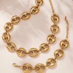 Stainless steel chunky coffee bean link chain necklace and matching bracelet set in gold, silver, and two-tone finishes.