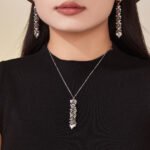 Gold and silver cascading heart tassel pendant necklace and drop earrings set model preview