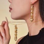 Gold and silver cascading heart tassel pendant necklace and drop earrings set model preview