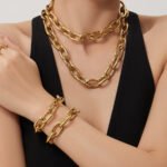 Bold oversized oval cable link chain necklace and matching bracelet jewelry set in 18K gold plated and polished silver stainless steel finishes.