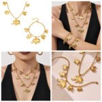 18K gold plated stainless steel elephant charm necklace and bracelet set featuring a prominent central elephant pendant and smaller charm accents on a beaded ball chain.