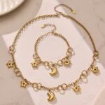 Stainless steel celestial star and cubic zirconia crescent moon charm necklace and matching charm bracelet set in gold and two-tone finishes.