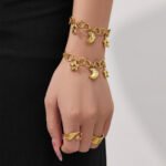 Stainless steel celestial star and cubic zirconia crescent moon charm necklace and matching charm bracelet set in gold and two-tone finishes.