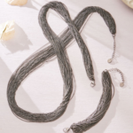Draped multi-strand liquid chain long necklace and wide cuff bracelet jewelry set in gold, silver, and two-tone stainless steel finishes.