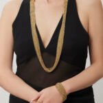 Draped multi-strand liquid chain long necklace and wide cuff bracelet jewelry set in gold, silver, and two-tone stainless steel finishes.