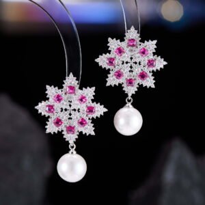 Snowflake CZ freshwater pearl drop earrings featuring an intricate starburst starburst pattern, princess-cut gems, micro-paved borders, and a round freshwater pearl dangle