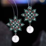 Snowflake CZ freshwater pearl drop earrings featuring an intricate starburst starburst pattern, princess-cut gems, micro-paved borders, and a round freshwater pearl dangle