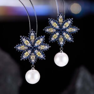 Snowflake CZ freshwater pearl drop earrings featuring an intricate starburst starburst pattern, princess-cut gems, micro-paved borders, and a round freshwater pearl dangle