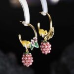 Hand-painted enamel squirrel and pearl blackberry cluster hoop earrings featuring white floral blossoms, a swinging pearl berry cluster, and 925 sterling silver ear posts