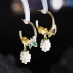 Hand-painted enamel squirrel and pearl blackberry cluster hoop earrings featuring white floral blossoms, a swinging pearl berry cluster, and 925 sterling silver ear posts