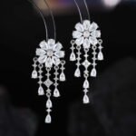 Floral CZ chandelier tassel earrings featuring a flower cluster stud, cascading teardrop gemstone fringes, and 925 sterling silver ear posts.