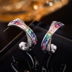 Rainbow CZ C-shape hoop earrings featuring channel-set multi-color square cubic zirconia, paved crossover border, and 925 sterling silver posts