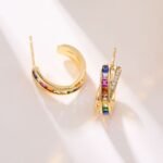 Rainbow CZ C-shape hoop earrings featuring channel-set multi-color square cubic zirconia, paved crossover border, and 925 sterling silver posts
