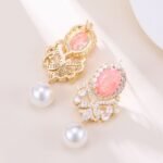 Vintage oval stone pearl drop earrings wholesale featuring an oval crackle gemstone surrounded by cubic zirconia halo, filigree chandelier dangles, and a freshwater pearl drop from junejewelry.com