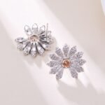 Micro pave CZ flower stud earrings featuring radiating textured petals encrusted with cubic zirconia, a amber crystal center, and 925 sterling silver posts