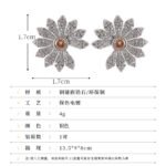 Micro pave CZ flower stud earrings featuring radiating textured petals encrusted with cubic zirconia, a amber crystal center, and 925 sterling silver posts