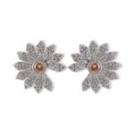 Micro pave CZ flower stud earrings featuring radiating textured petals encrusted with cubic zirconia, a amber crystal center, and 925 sterling silver posts