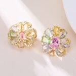 Floral pinwheel CZ cluster stud earrings featuring a swirling halo of multi-cut gemstones, micro-paved ribbon swirls, and 925 sterling silver ear posts