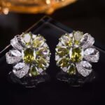 Floral pinwheel CZ cluster stud earrings featuring a swirling halo of multi-cut gemstones, micro-paved ribbon swirls, and 925 sterling silver ear posts