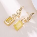 Crackle ice flower CZ wing drop earrings featuring a swept pavé wing design and rectangular ice crackle gem with 925 sterling silver posts