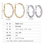 Cubic zirconia oval hoop earrings featuring continuous prong-set round stones, available in gold and silver tones in two sizes.
