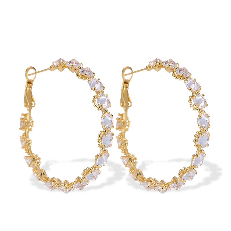 Cubic zirconia oval hoop earrings featuring continuous prong-set round stones, available in gold and silver tones in two sizes.