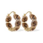 Oval halo CZ hoop earrings featuring faceted oval crystal main stones surrounded by micro-pavé halos on a thick hoop frame with 925 sterling silver posts.