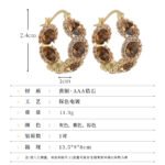Oval halo CZ hoop earrings featuring faceted oval crystal main stones surrounded by micro-pavé halos on a thick hoop frame with 925 sterling silver posts.