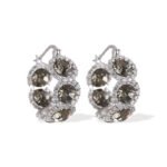 Oval halo CZ hoop earrings featuring faceted oval crystal main stones surrounded by micro-pavé halos on a thick hoop frame with 925 sterling silver posts.