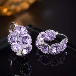 Oval halo CZ hoop earrings featuring faceted oval crystal main stones surrounded by micro-pavé halos on a thick hoop frame with 925 sterling silver posts.