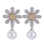 Daisy CZ pearl drop earrings featuring a full pavé crystal flower stud with a yellow CZ pistil center, high-lustre pearl drop, and 925 sterling silver ear posts.