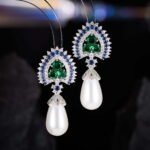 Royal teardrop pearl drop earrings wholesale featuring colorful CZ halo crests, pavé caps, and large teardrop pearls with 925 sterling silver posts from junejewelry.com