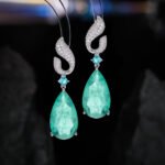 Teardrop gemstone drop earrings wholesale featuring a pavé cubic zirconia flame-top design, a small round gemstone accent, and a large pear-cut crystal drop with 925 silver posts from junejewelry.com