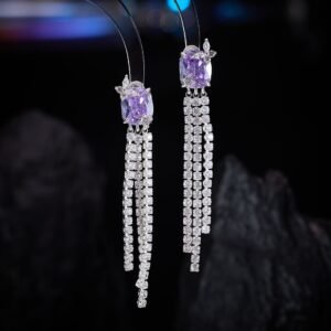 Long tassel CZ drop earrings featuring a cushion-cut colored crystal stud with marquee crystal butterfly accents and cascading cubic zirconia fringe strands on palladium-plated brass with 925 sterling silver posts.