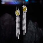 Long tassel CZ drop earrings featuring a cushion-cut colored crystal stud with marquee crystal butterfly accents and cascading cubic zirconia fringe strands on palladium-plated brass with 925 sterling silver posts.