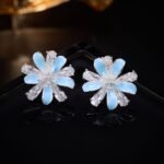 Layered bloom stud earrings featuring alternating glossy enamel petals and marquise-cut clear CZ crystals, available in yellow, sky blue, and pastel rainbow options.