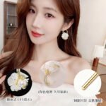 Mother of pearl flower hoop earrings with natural carved shell petals, AAA cubic zirconia accents, and gold-plated huggie hoop closure.