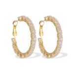 Round hoop earrings set with continuous sparkling clear cubic zirconia crystals, available in gold and silver finishes.
