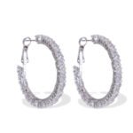 Round hoop earrings set with continuous sparkling clear cubic zirconia crystals, available in gold and silver finishes.