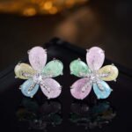 Five-petal flower stud earrings crafted with pear-cut crackle glass stones, featuring a pavé crystal starfish centerpiece in pink, green, and pastel rainbow colorways.