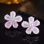 Five-petal flower stud earrings crafted with pear-cut crackle glass stones, featuring a pavé crystal starfish centerpiece in pink, green, and pastel rainbow colorways.